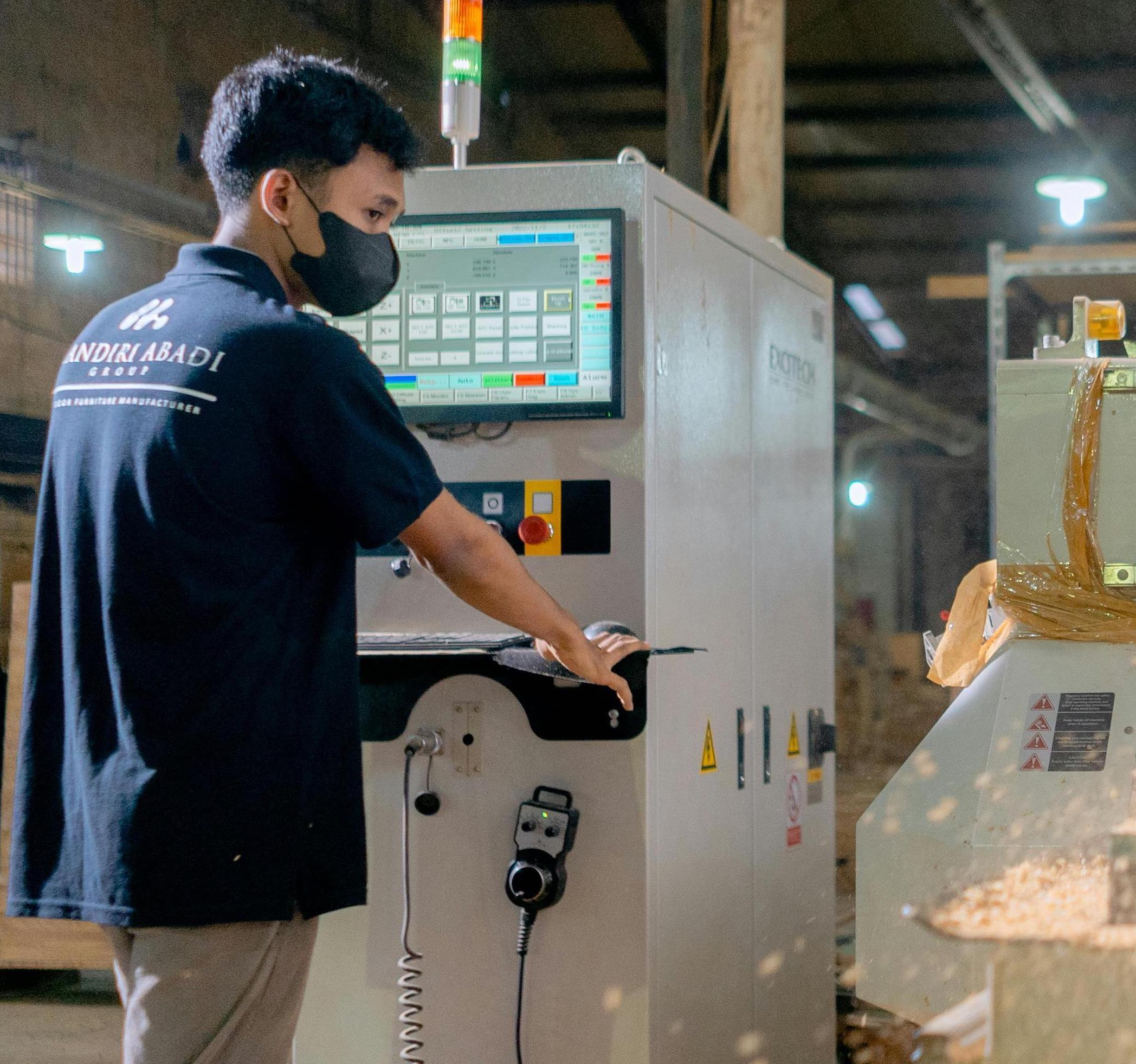 man working in a facility wearing a mask